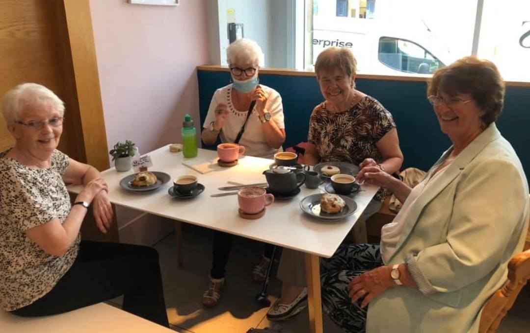 A group of participants in the Golden Years befriending project at the cafe of the Dovecote Gallery
