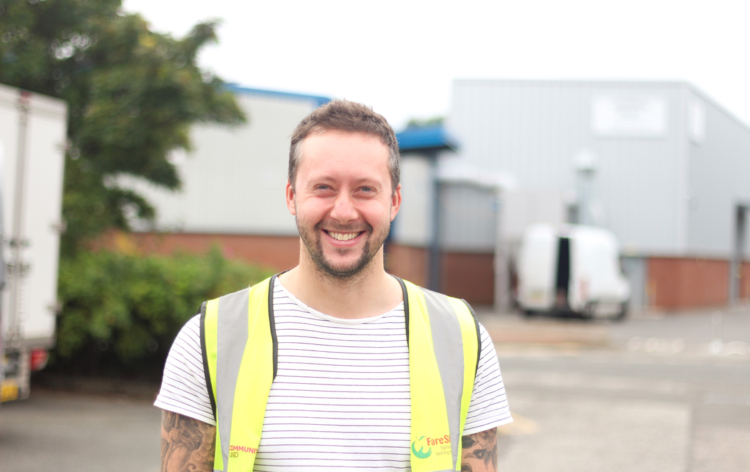 smiling staff member high vis