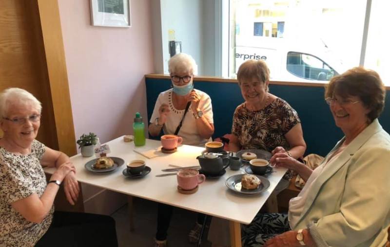 A group of participants in the Golden Years befriending project at the cafe of the Dovecote Gallery